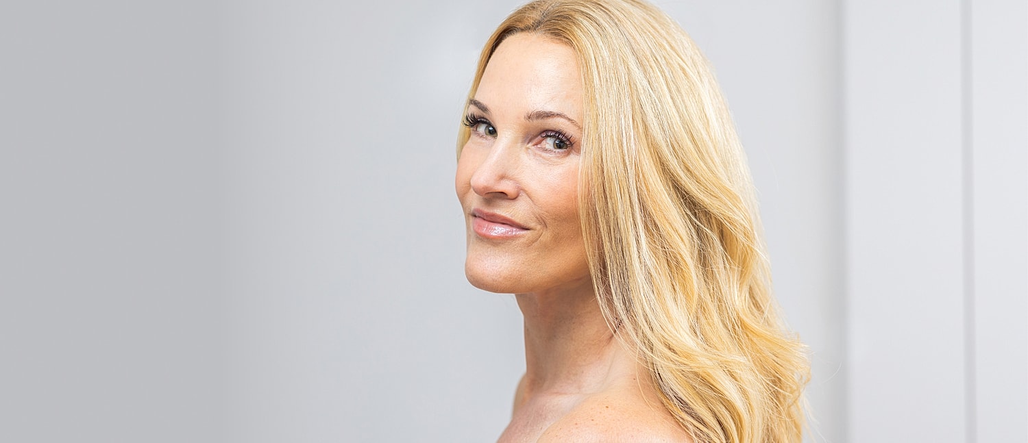 Smiling woman with long, flowing blonde hair.