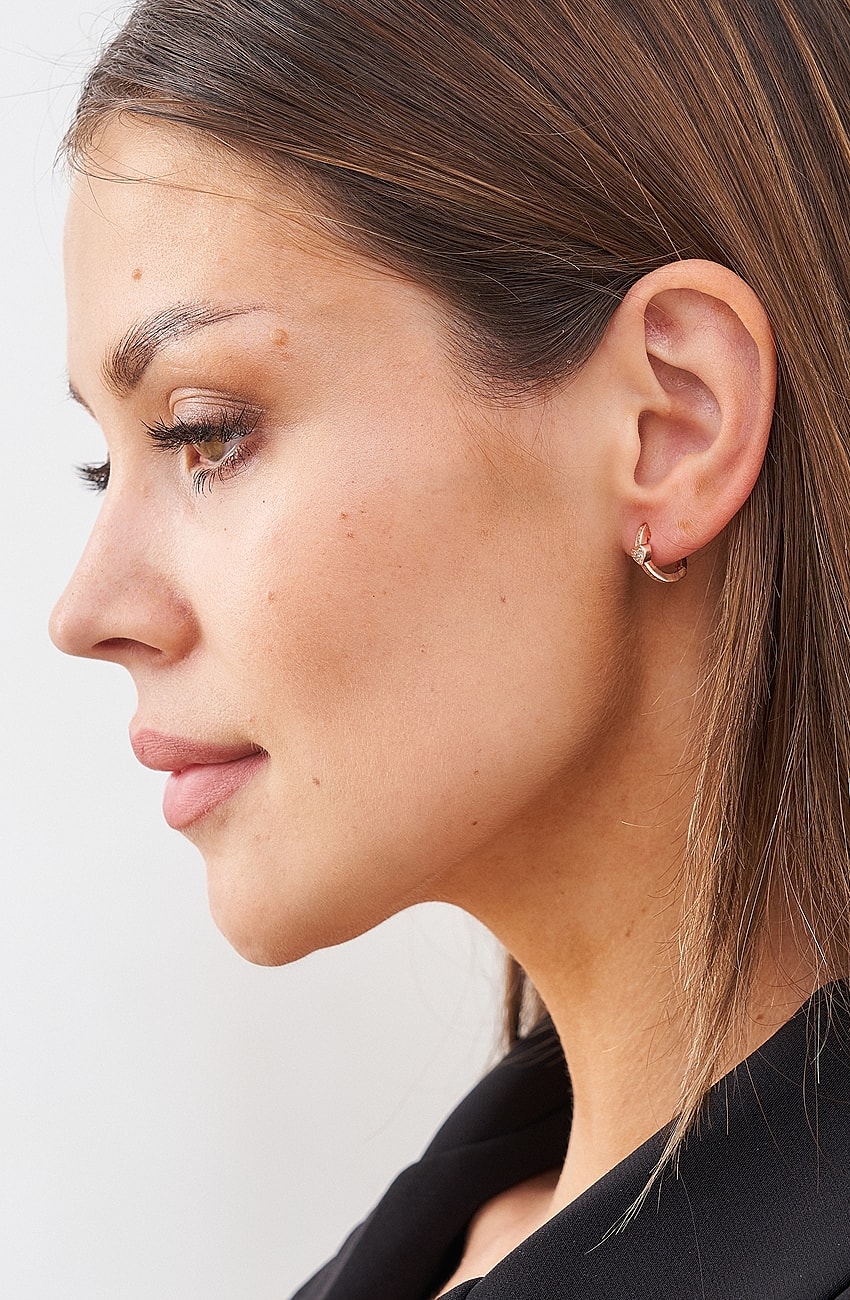 Profile view of a woman with earrings.