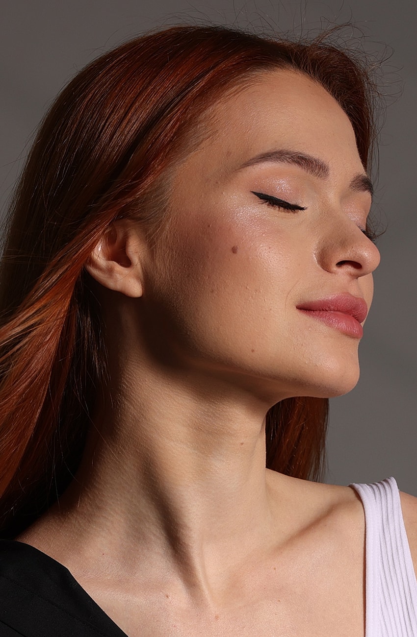 Profile of a woman with red hair.