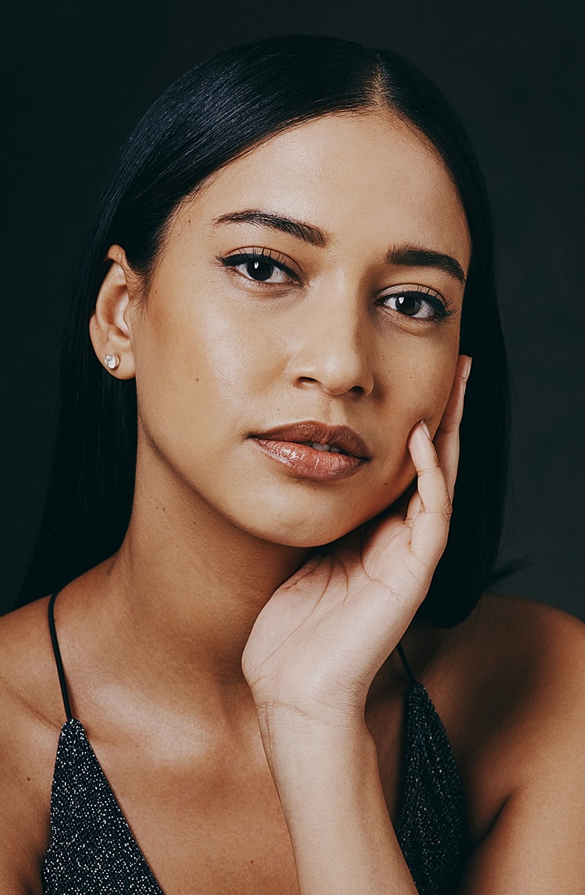 Portrait of a woman touching her face.