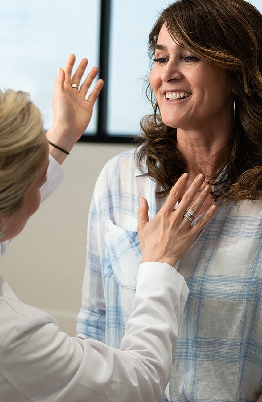 Doctor consulting with patient in a bright room.