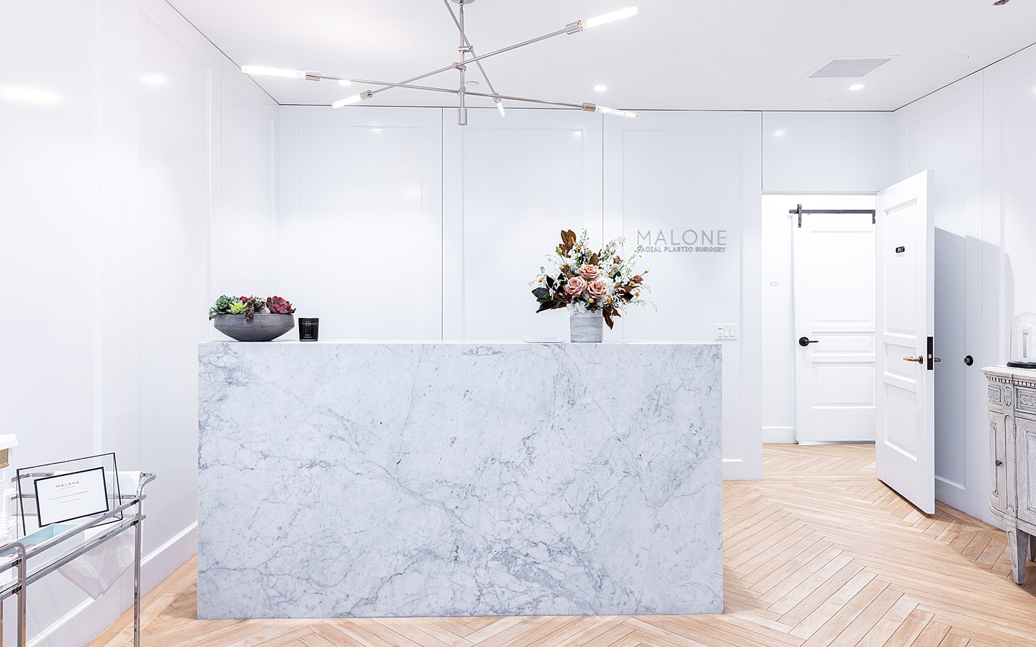 Modern clinic reception with marble counter and lighting