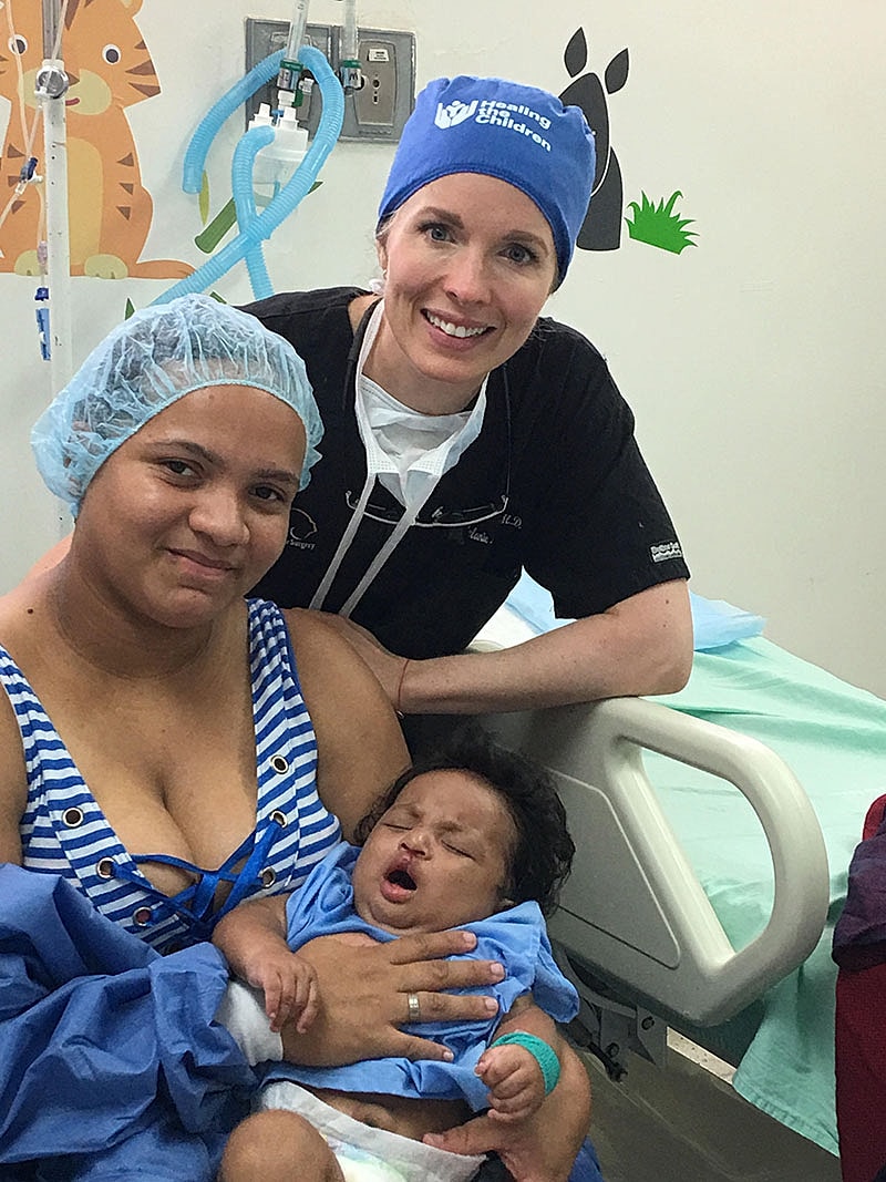 Dr Malone Facial Plastic Surgeon San DiegoMother and child with healthcare professional in hospital.