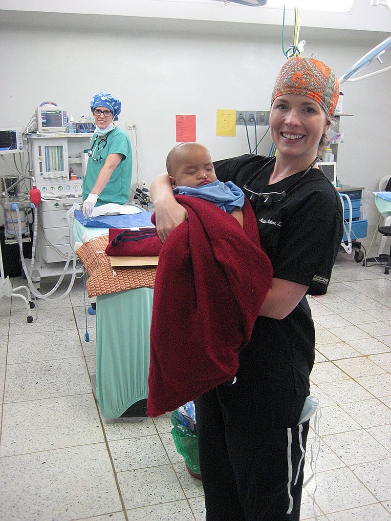 Dr Malone Facial Plastic Surgeon San DiegoMedical professionals caring for a sleeping child.