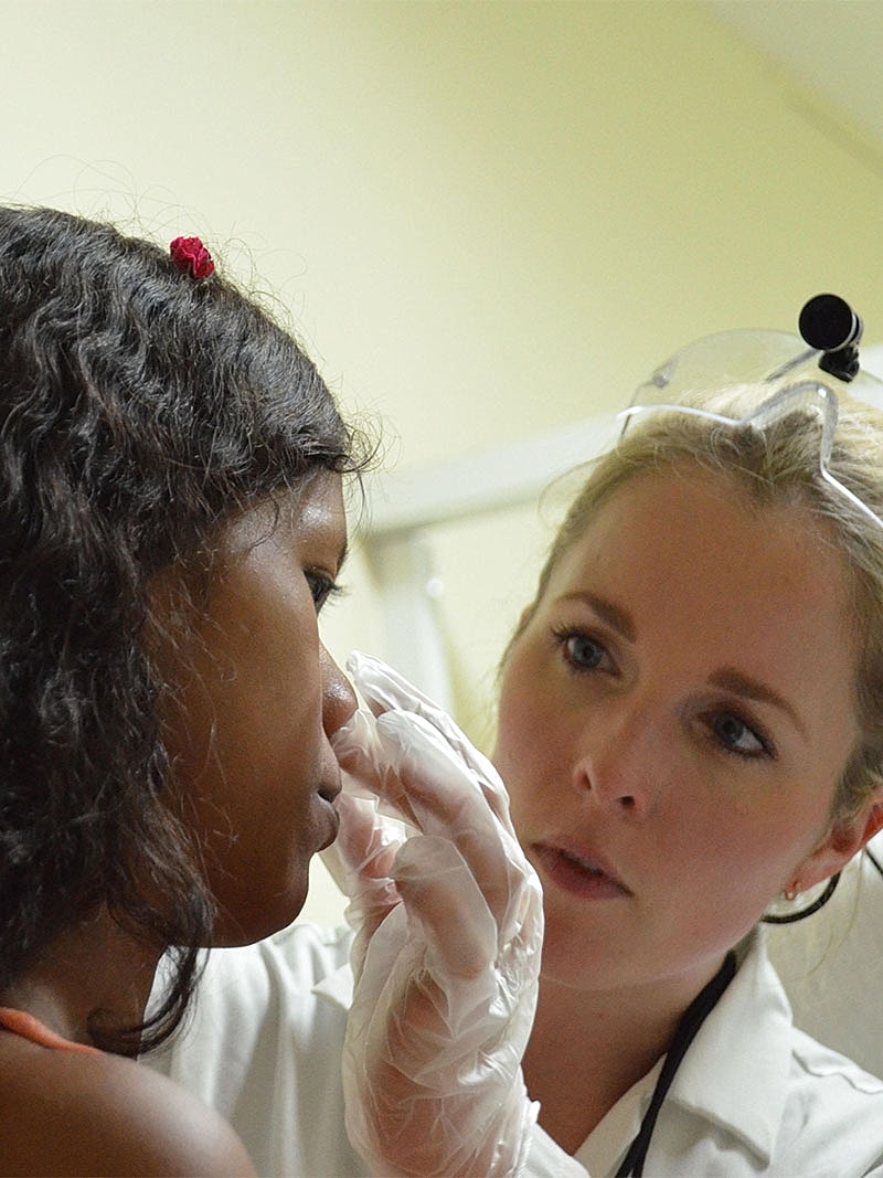 Dr Malone Facial Plastic Surgeon San DiegoChild receiving medical examination from healthcare professional.