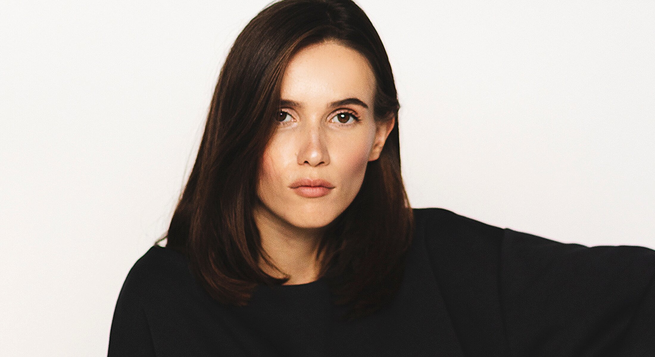 Woman with long hair against a white background.