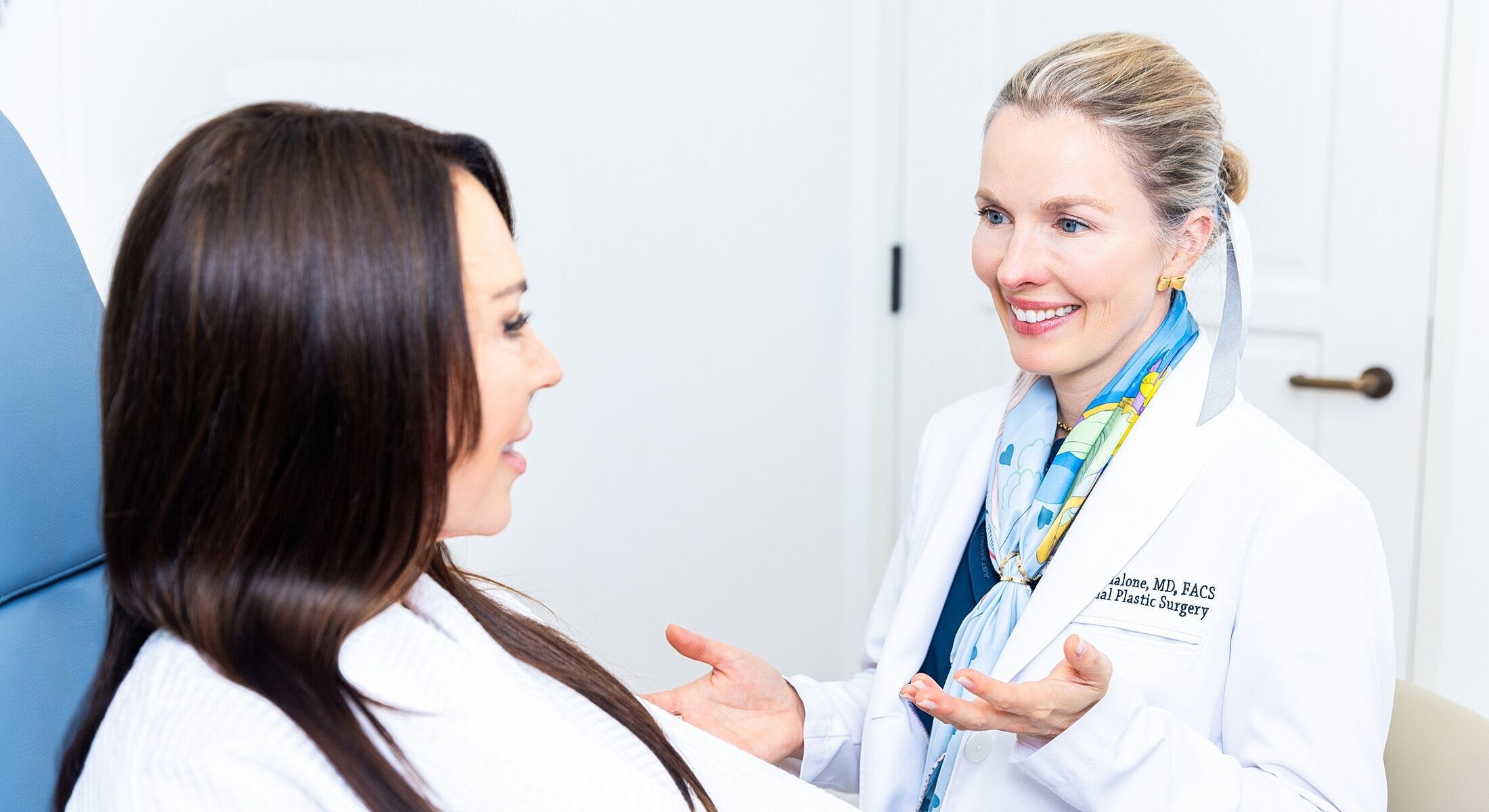 Doctor consulting with patient in clinic setting.