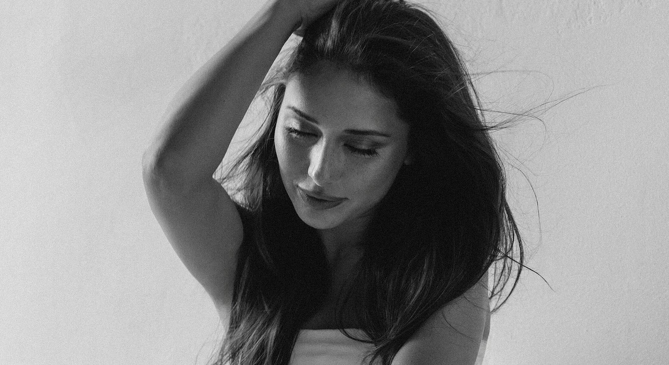 Woman with long hair in monochrome photo.