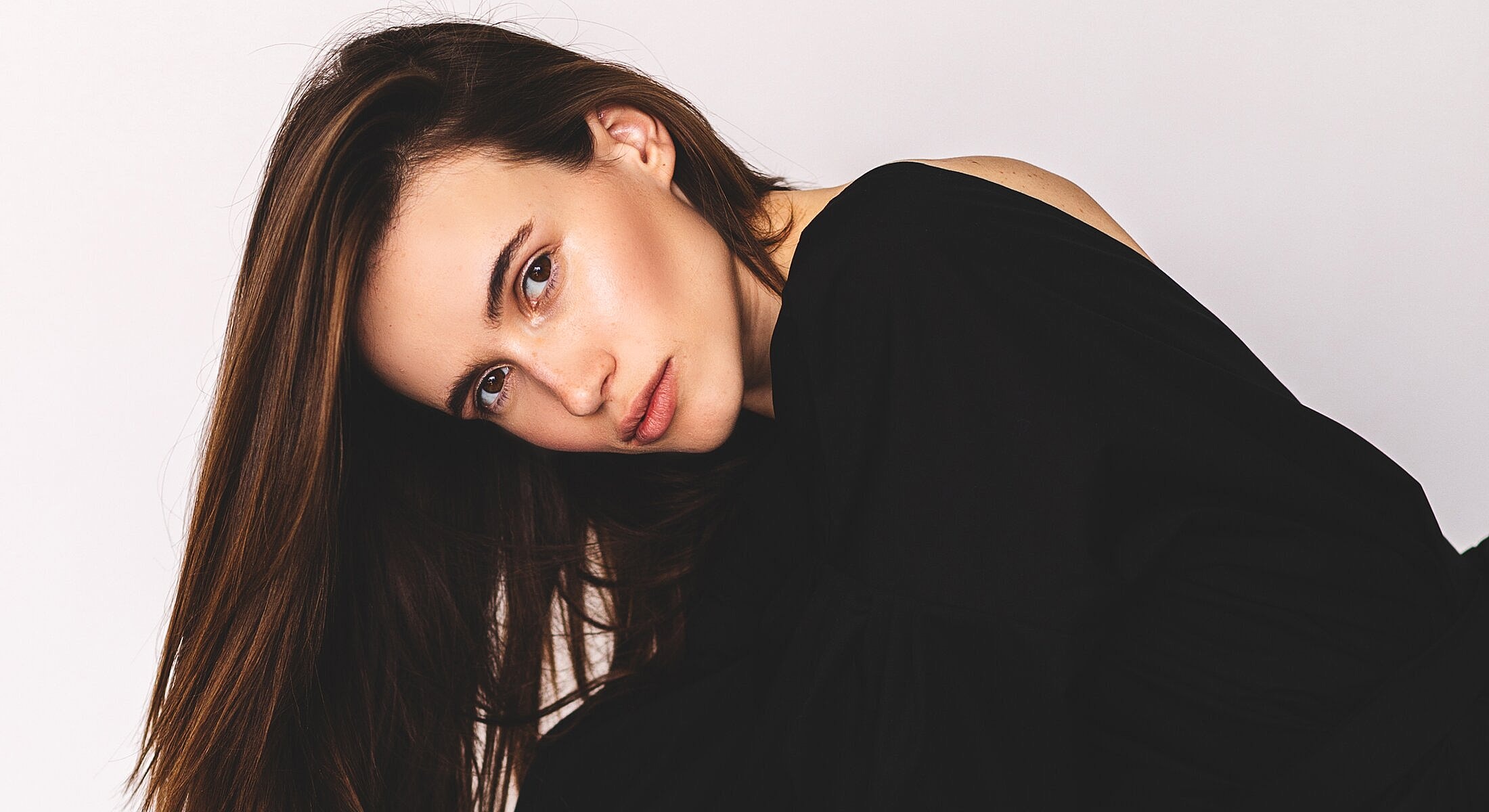 Woman with long hair in black top.