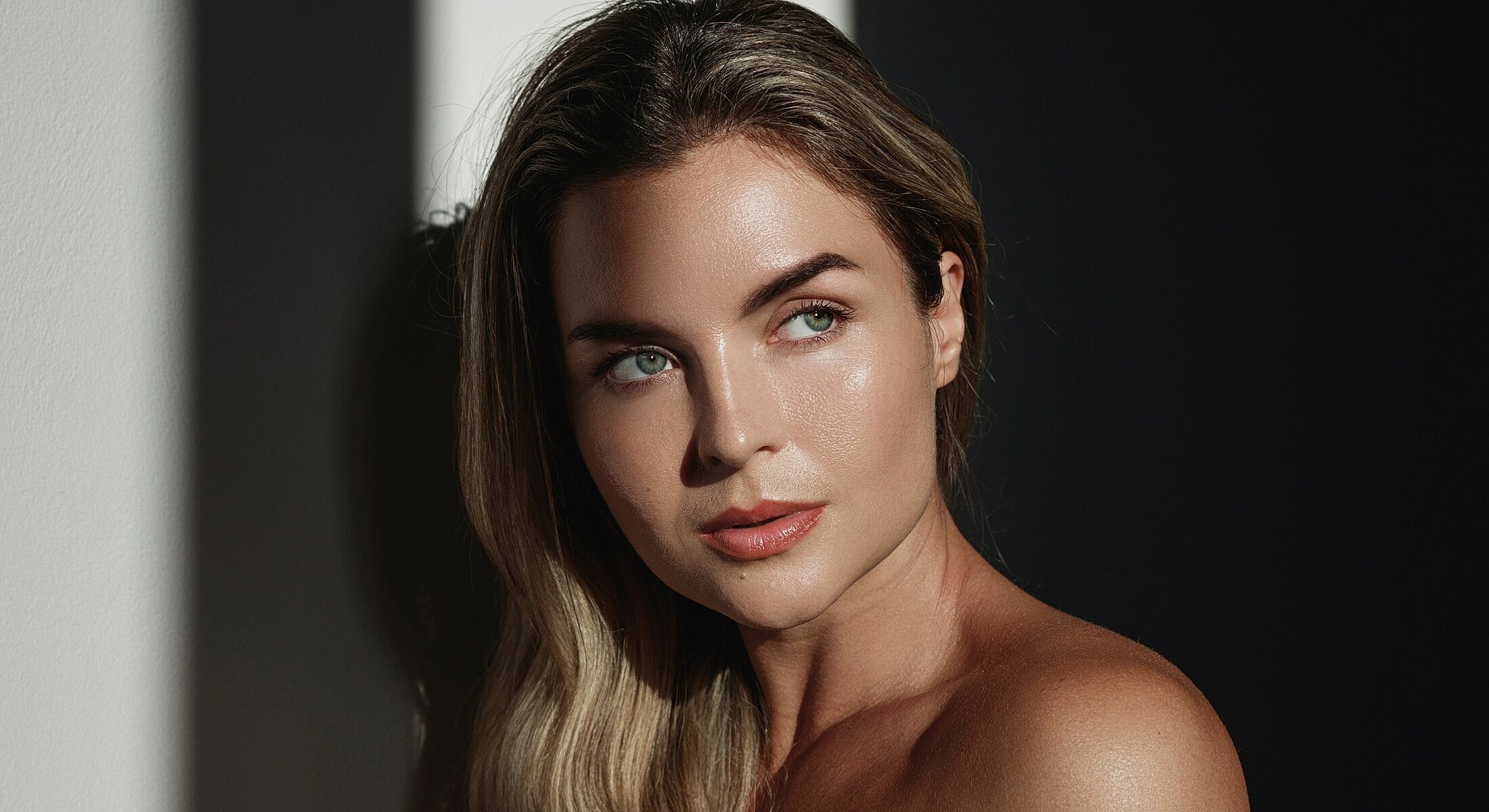 Portrait of a woman with natural lighting contrast.