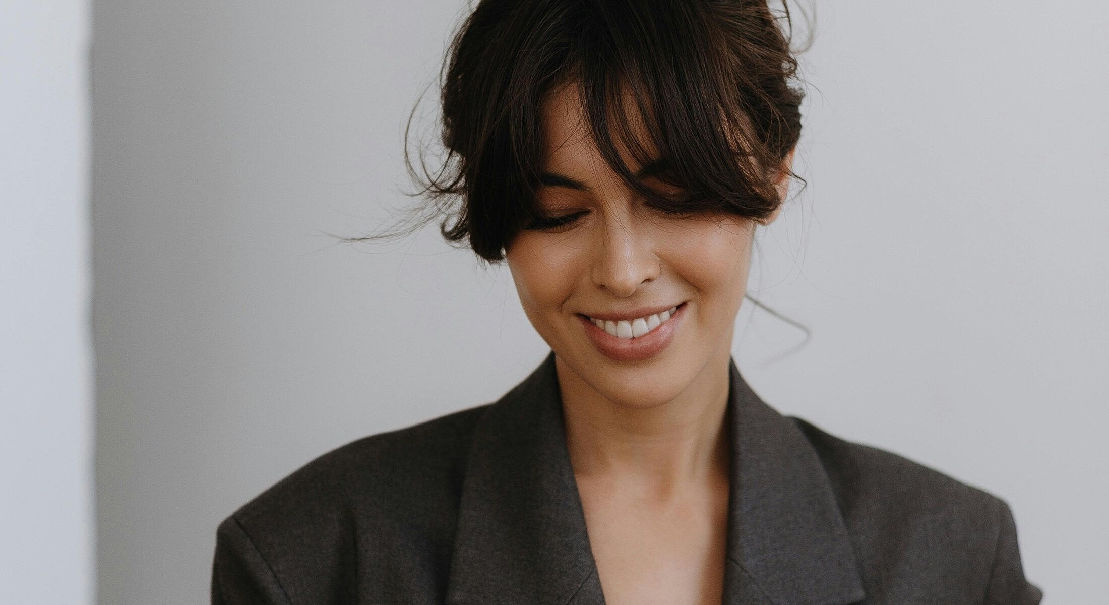 Smiling woman in a stylish blazer.